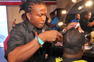 Sly Scott, (left) applies the finishing touches to his model’s hairstyle during last year’s JNSBL Barber and Beauty Challenge held at the Jamaica Pegasus hotel. Mr. Scott finished first in the competition.
