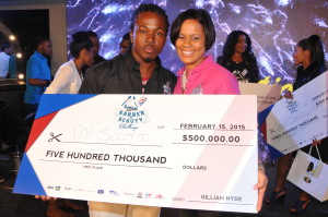 Mrs Gillian Hyde (right) General Manager of JN Small Business Loans presents a cheque to Mr. Sly Scott after he finished first in the JNSBL Barber and Beauty Challenge at the Jamaica Pegasus last year.