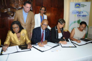 From (left) Audrey Sewell, Permanent Secretary in the Ministry of Economic Growth and Job Creation; Milverton Reynolds Managing Director of the Development Bank of Jamaica; Gillian Hyde, General Manager of JN Small Business Loans and Allison Rangolan McFarlane, Programme Manager, (Environmental Foundation of Jamaica sign a Memorandum of Understanding (MOU) to facilitate the administration of the Climate Change Adaptation Line of Credit (CCALoC). The CCALoC will provide financing to Micro, Small and Medium Size Enterprises (MSMEs) in the tourism and agri-business sectors across Jamaica, to increase resilience to climate change in these sectors. The signing took place at the Office of the Prime Minister in St. Andrew on Thursday.  Looking on are Minister with Portfolio in the Office of the Prime Minister with responsibility for Economic Growth and Job Creation, Daryl Vaz and Therese Turner-Jones, General Manager Inter-American Development Bank (IDB) Caribbean Department.   The loan facility will be administered under the Climate Smart Loan product with clients being able to borrow up to J$5 million.